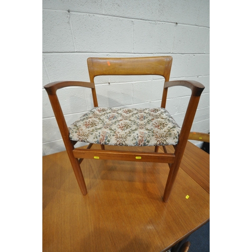 1201 - A MID CENTURY DANISH TEAK DINING TABLE, each end extending to reveal a leaf storage compartment, two... 