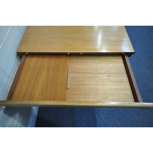 1201 - A MID CENTURY DANISH TEAK DINING TABLE, each end extending to reveal a leaf storage compartment, two... 