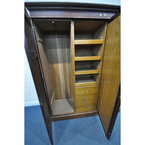 1215 - AN EDWARDIAN MAHOGANY COMPACTUM WARDROBE, the two cupboard doors flanking a central bevelled mirror ... 