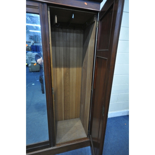 1215 - AN EDWARDIAN MAHOGANY COMPACTUM WARDROBE, the two cupboard doors flanking a central bevelled mirror ... 