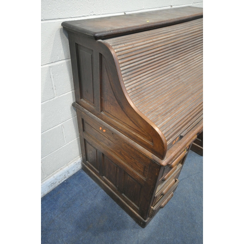 1226 - A GLOBE WERNICKE 20TH CENTURY OAK TAMBOUR FRONT DESK, with a fitted interior, raised on twin pedesta... 