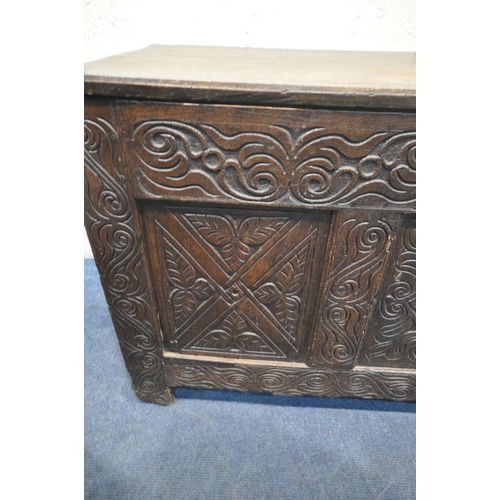 1228 - A GEORGIAN AND LATER OAK BLANKET CHEST, the front panel with geometric carvings, width 125cm x depth... 