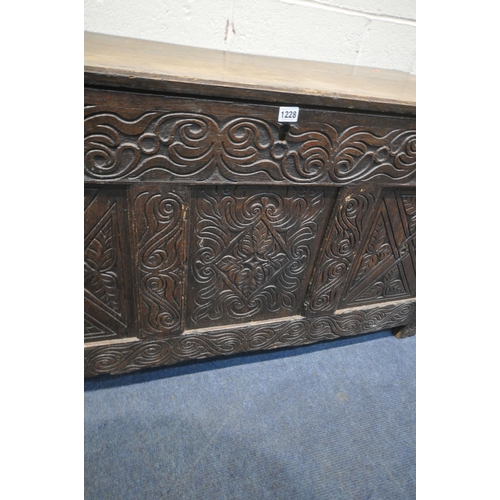 1228 - A GEORGIAN AND LATER OAK BLANKET CHEST, the front panel with geometric carvings, width 125cm x depth... 