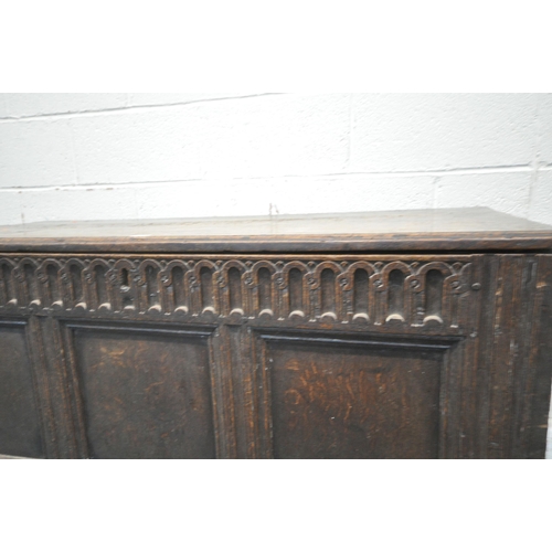 1230 - A GEORGIAN AND LATER OAK COFFER, the hinged lid enclosing a candle box, geometric carving to front a... 