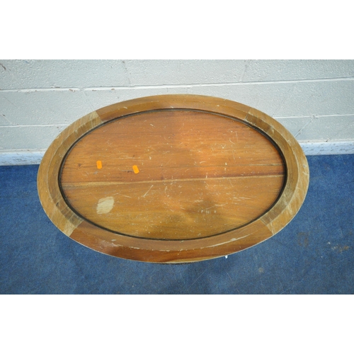 1232 - A REPRODUCTION HARDWOOD OVAL TRAY TOP COCKTAIL CABINET, with a single door, bevelled glass panes all... 