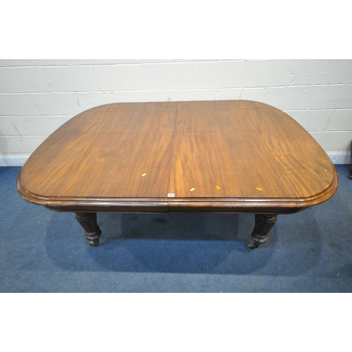 1233 - A LARGE VICTORIAN MAHOGANY WIND OUT DINING TABLE, with two additional leaves, raised on turned and t... 