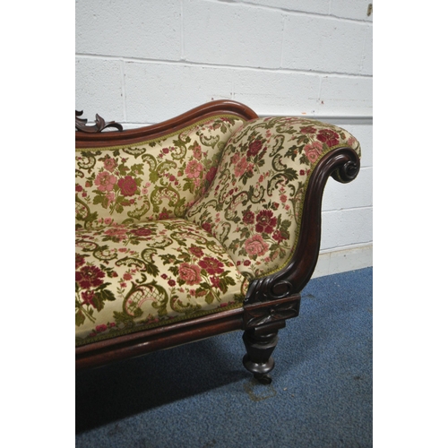 1258 - A VICTORIAN MAHOGANY SOFA, with scrolled armrests, wavy back and foliate carved centre, on octagonal... 