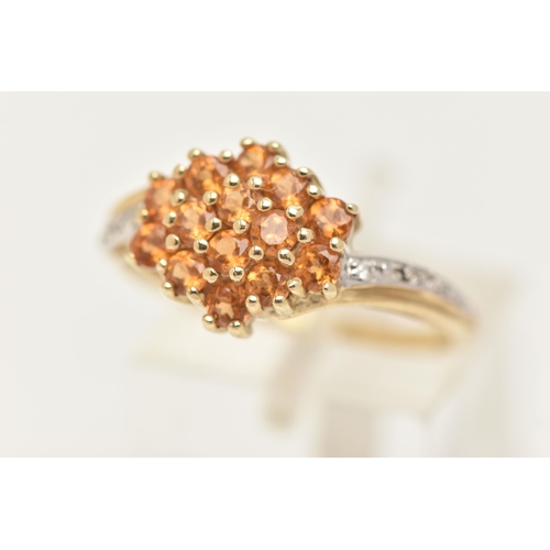 10 - A 9CT GOLD CITRINE AND DIAMOND RING, designed as a cluster of circular cut Citrine, cross over shoul... 