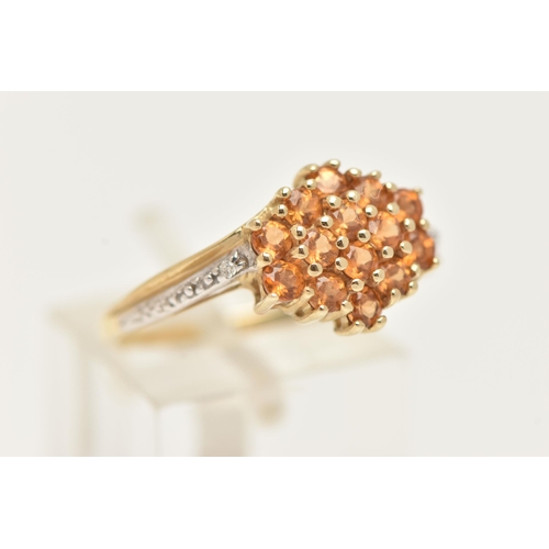 10 - A 9CT GOLD CITRINE AND DIAMOND RING, designed as a cluster of circular cut Citrine, cross over shoul... 