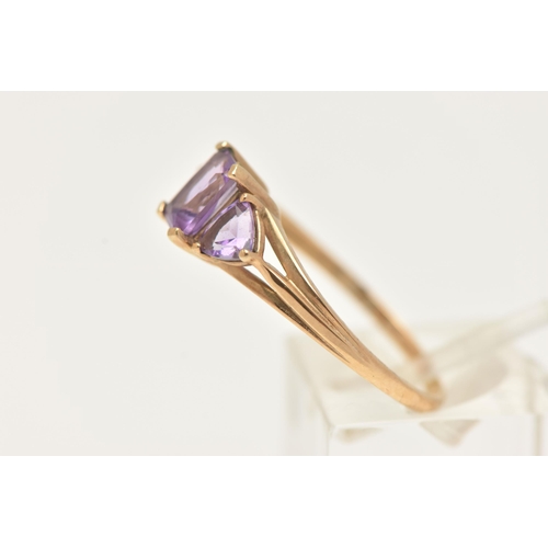 11 - A 9CT GOLD AMETHYST RING, set with a central rectangular cut amethyst in a four claw setting, flanke... 