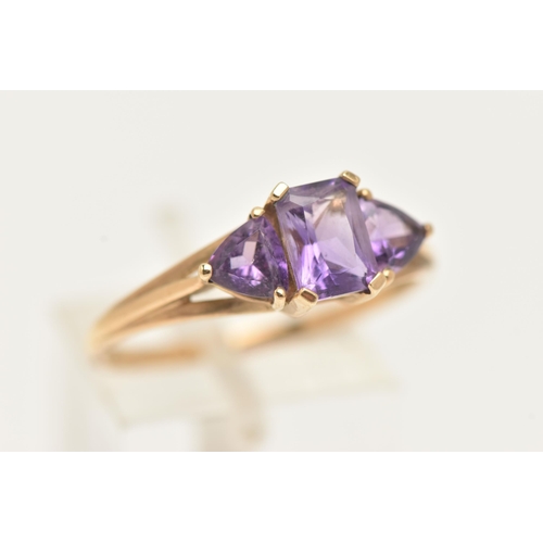 11 - A 9CT GOLD AMETHYST RING, set with a central rectangular cut amethyst in a four claw setting, flanke... 