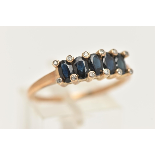 12 - A 9CT GOLD SAPPHIRE AND DIAMOND RING, designed as a row of five oval cut deep blue sapphires, shared... 