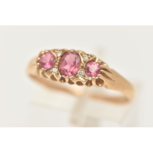 13 - A 9CT GOLD PINK TOURMALINE AND DIAMOND RING, set with a central oval cut pink tourmaline, flanked wi... 