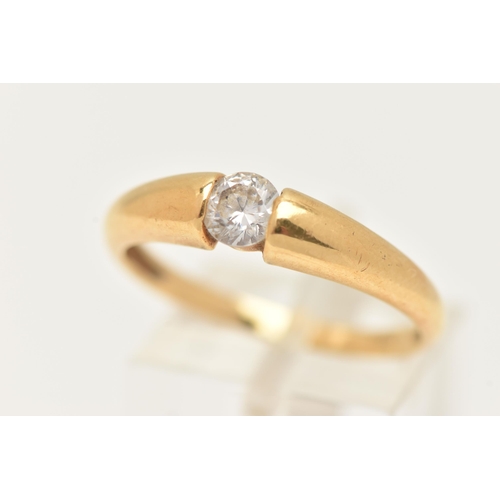 14 - AN 18CT GOLD SINGLE STONE RING, set with a colourless circular cut cubic zirconia, tension set to a ... 