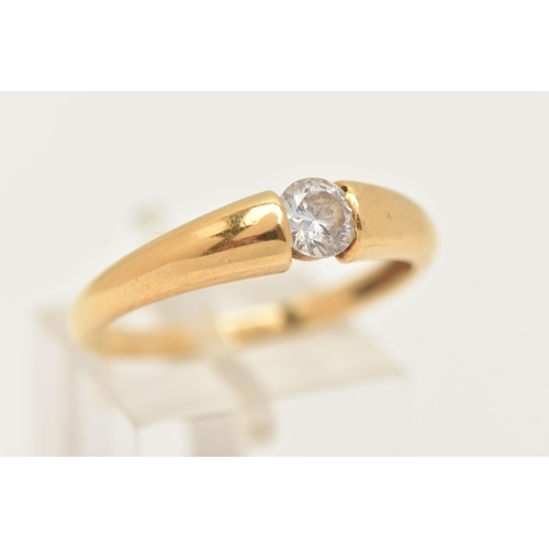 14 - AN 18CT GOLD SINGLE STONE RING, set with a colourless circular cut cubic zirconia, tension set to a ... 