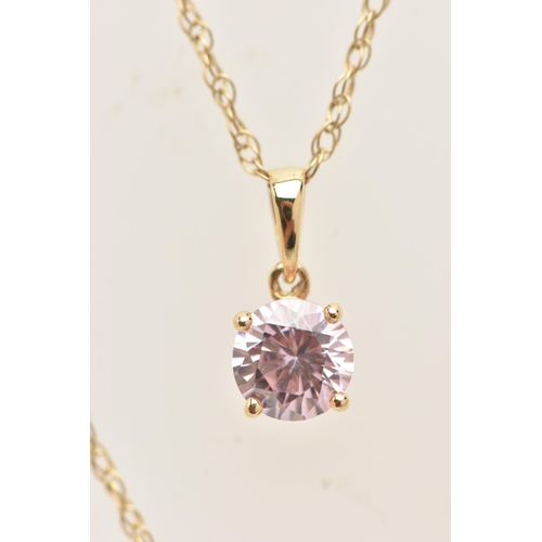 17 - A YELLOW METAL PENDANT NECKLACE, the pendant set with a circular cut pink cubic zirconia, in a four ... 