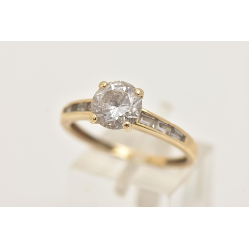 2 - A 14CT GOLD CUBIC ZIRCONIA RING, set with a central circular cut colourless cubic zirconia, and bagu... 