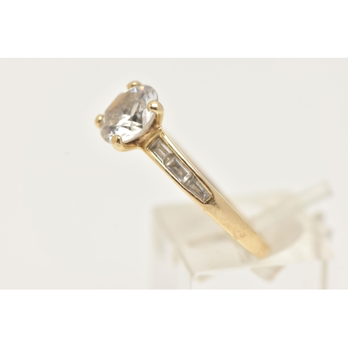 2 - A 14CT GOLD CUBIC ZIRCONIA RING, set with a central circular cut colourless cubic zirconia, and bagu... 