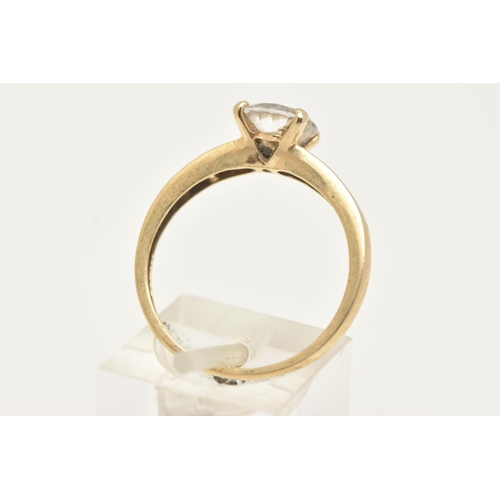 2 - A 14CT GOLD CUBIC ZIRCONIA RING, set with a central circular cut colourless cubic zirconia, and bagu... 