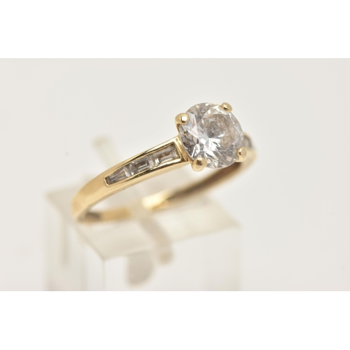 2 - A 14CT GOLD CUBIC ZIRCONIA RING, set with a central circular cut colourless cubic zirconia, and bagu... 