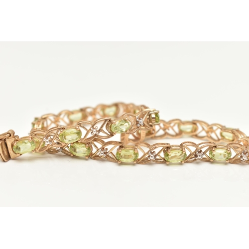 20 - A 9CT GOLD PERIDOT LINE BRACELET, designed as a series of seventeen oval cut peridots, each in a fou... 