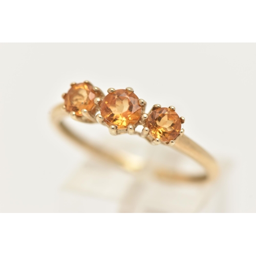 3 - A 9CT GOLD CITRINE RING, set with three circular cut citrines, each in a claw setting, leading onto ... 