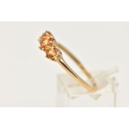 3 - A 9CT GOLD CITRINE RING, set with three circular cut citrines, each in a claw setting, leading onto ... 