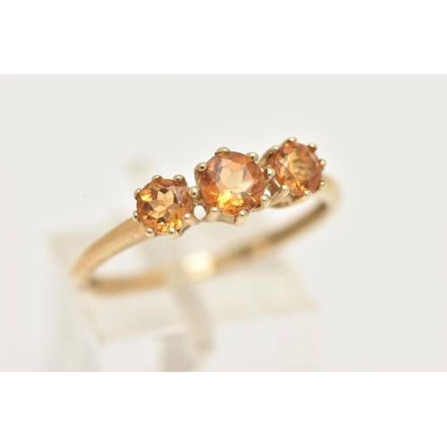 3 - A 9CT GOLD CITRINE RING, set with three circular cut citrines, each in a claw setting, leading onto ... 