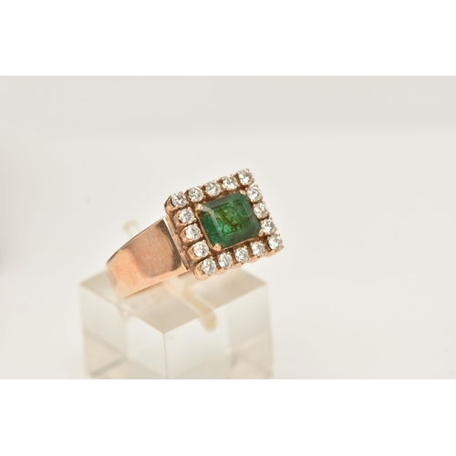 40 - AN EMERALD AND DIAMOND CLUSTER RING, set with a square shape emerald, measuring approximately 7.09 b... 