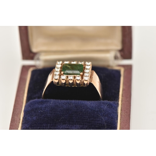 40 - AN EMERALD AND DIAMOND CLUSTER RING, set with a square shape emerald, measuring approximately 7.09 b... 