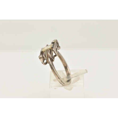 49 - A WHITE METAL DIAMOND DRESS RING, set with a principal baguette cut diamond, measuring approximately... 