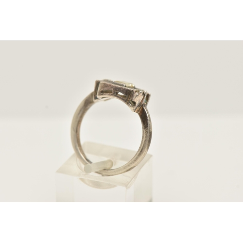 49 - A WHITE METAL DIAMOND DRESS RING, set with a principal baguette cut diamond, measuring approximately... 