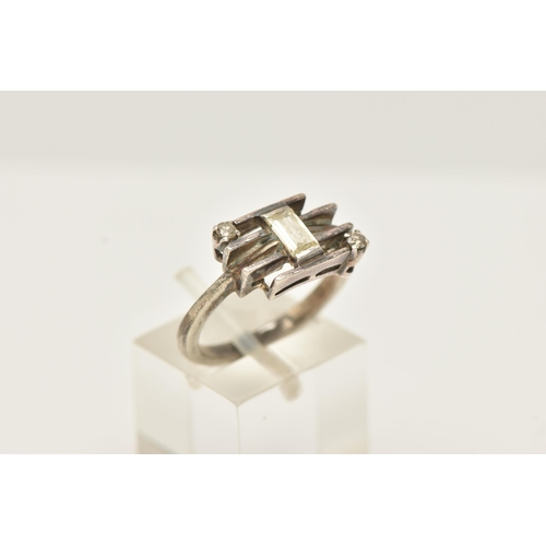 49 - A WHITE METAL DIAMOND DRESS RING, set with a principal baguette cut diamond, measuring approximately... 