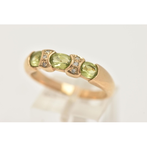 5 - A 9CT GOLD PERIDOT AND DIAMOND DRESS RING, set with three oval cut peridots with single cut diamond ... 