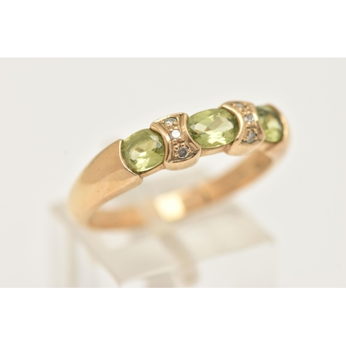 5 - A 9CT GOLD PERIDOT AND DIAMOND DRESS RING, set with three oval cut peridots with single cut diamond ... 