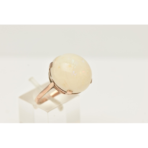 50 - A YELLOW METAL OPAL SINGLE STONE RING, set with an opal cabochon, measuring approx 16.72 by 17.50mm,... 