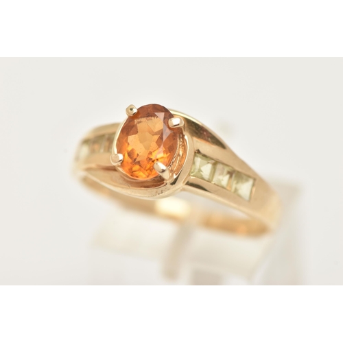 6 - A 9CT GOLD CITRINE RING, set with a central oval cut Citrine, in a four claw setting, cross over sho... 