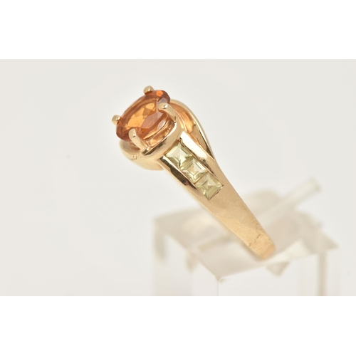 6 - A 9CT GOLD CITRINE RING, set with a central oval cut Citrine, in a four claw setting, cross over sho... 