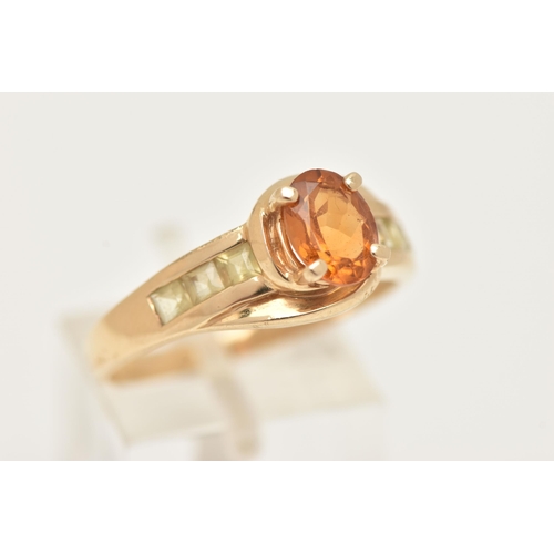 6 - A 9CT GOLD CITRINE RING, set with a central oval cut Citrine, in a four claw setting, cross over sho... 