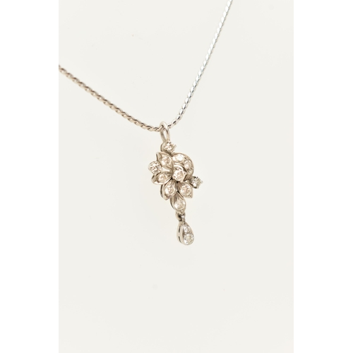 61 - A WHITE METAL DIAMOND PENDANT AND CHAIN, the floral diamond pendant set throughout with approx fourt... 