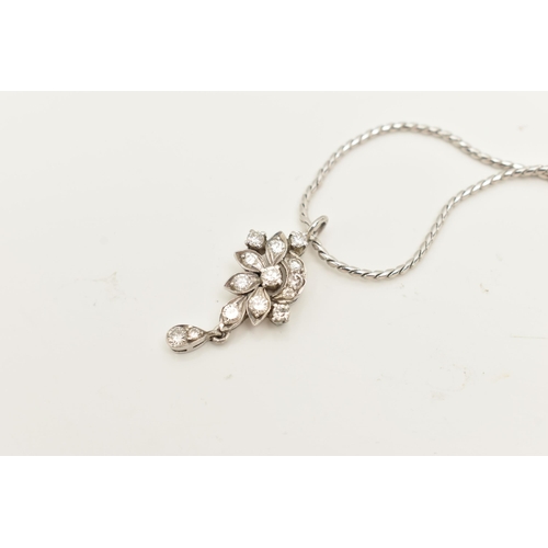 61 - A WHITE METAL DIAMOND PENDANT AND CHAIN, the floral diamond pendant set throughout with approx fourt... 