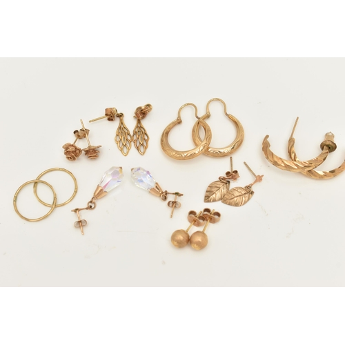 66 - A COLLECTION OF NINE YELLOW METAL EARRINGS, to include a pair of rose bud ear studs, a pair of textu... 