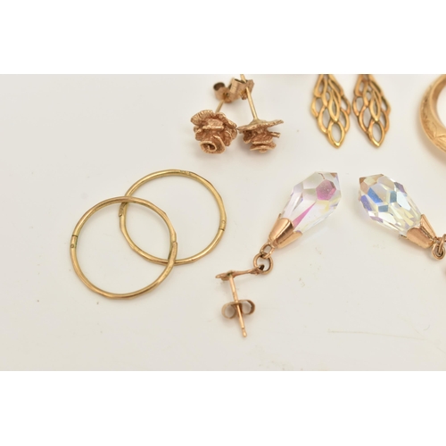 66 - A COLLECTION OF NINE YELLOW METAL EARRINGS, to include a pair of rose bud ear studs, a pair of textu... 