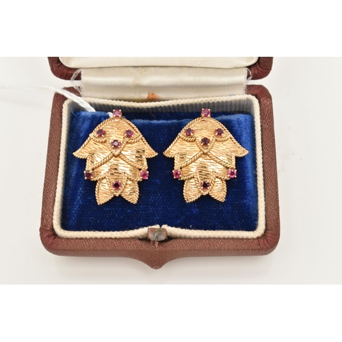 68 - A PAIR OF YELLOW METAL RUBY EARRINGS, each ear clip of foliate design set throughout with seven ruby... 