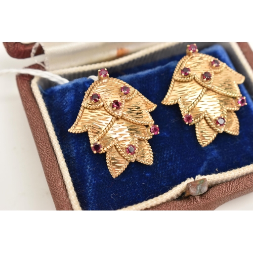 68 - A PAIR OF YELLOW METAL RUBY EARRINGS, each ear clip of foliate design set throughout with seven ruby... 