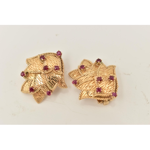 68 - A PAIR OF YELLOW METAL RUBY EARRINGS, each ear clip of foliate design set throughout with seven ruby... 