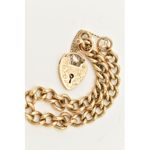 71 - A 9CT GOLD CURB LINK BRACELET, some links stamped 9.375, hallmarked London, fitted with a heart padl... 