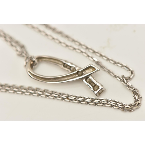 79 - A WHITE METAL DIAMOND SET PENDANT WITH A 9CT WHITE GOLD CHAIN, the ribbon pendant set with five grad... 