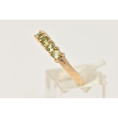 8 - A 9CT GOLD SEVEN STONE RING, set with seven circular cut green stones believed to be peridot, each i... 