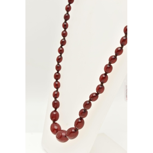 83 - A BAKELITE CHERRY AMBER COLOUR NECKLACE, graduated oval beads forty-nine beads in total, largest mea... 